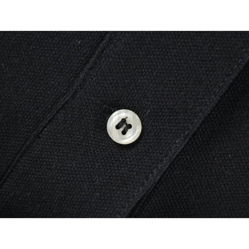 Close-up of button detail on the garment