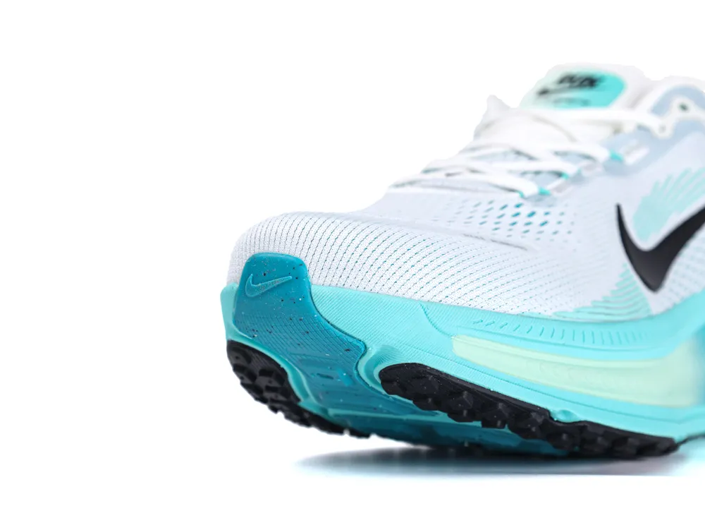White and teal mesh sneaker with black rubber sole and visible logo.