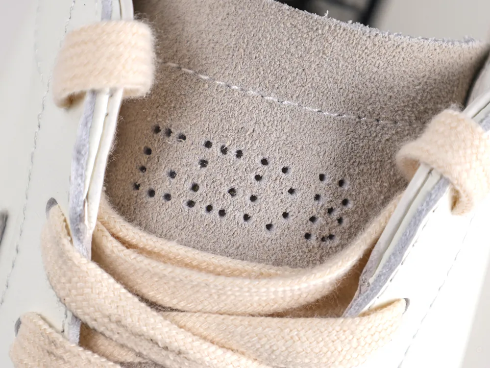 Interior view of Golden Goose sneaker showing grey suede and cream laces