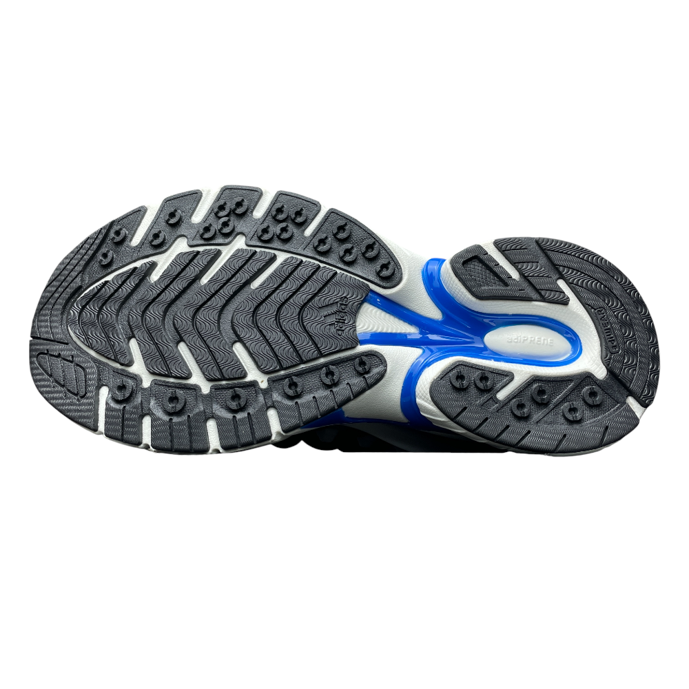 Close-up of a sneaker with white mesh fabric, blue and beige rubber accents, and striped laces, showcasing intricate detailing.