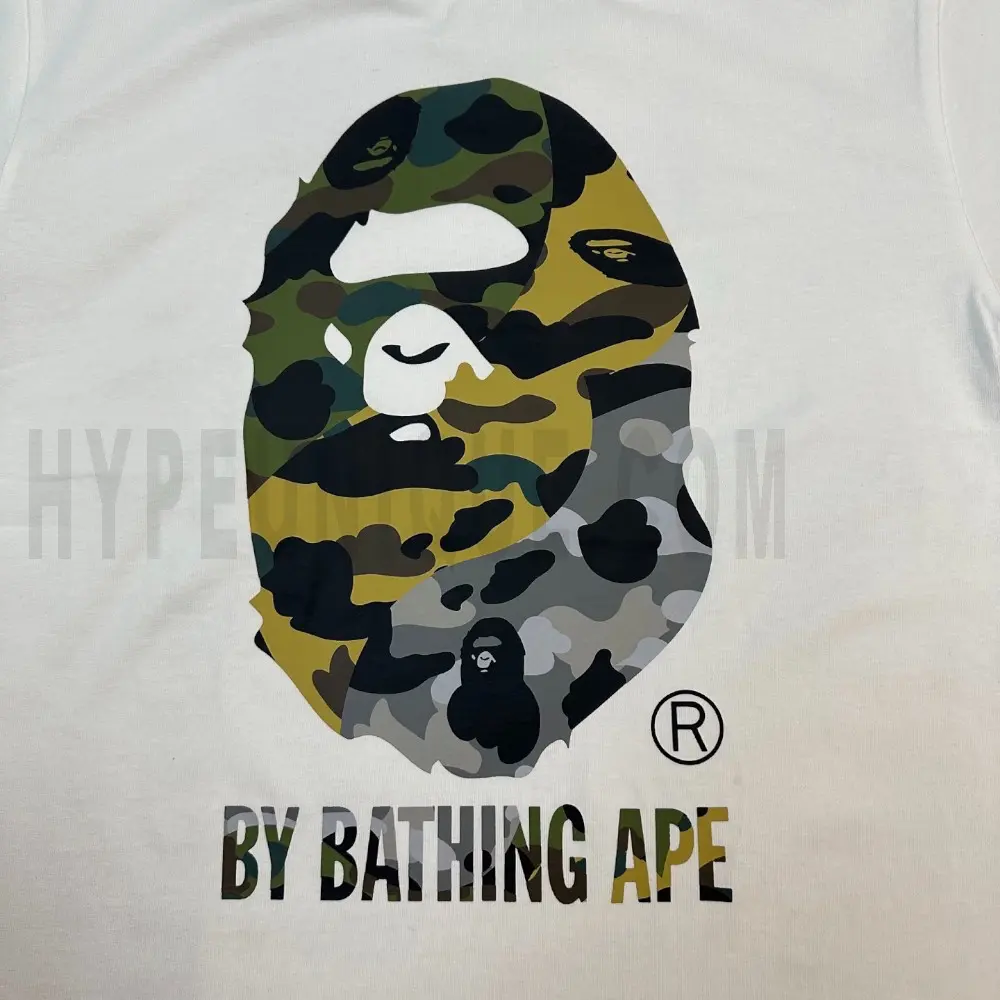 Detailed shot capturing the graphic print on the white tee's front panel.