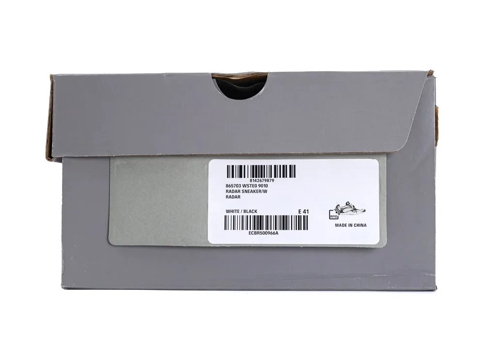 Gray cardboard sneaker box with a white and black label on the side.
