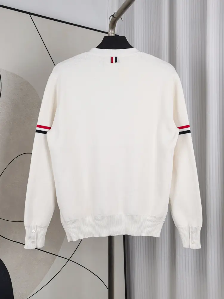 A back view of the Fine Merino Wool RWB Armband Cardigan in lright white, showcasing its deep light white merino wool material and design.