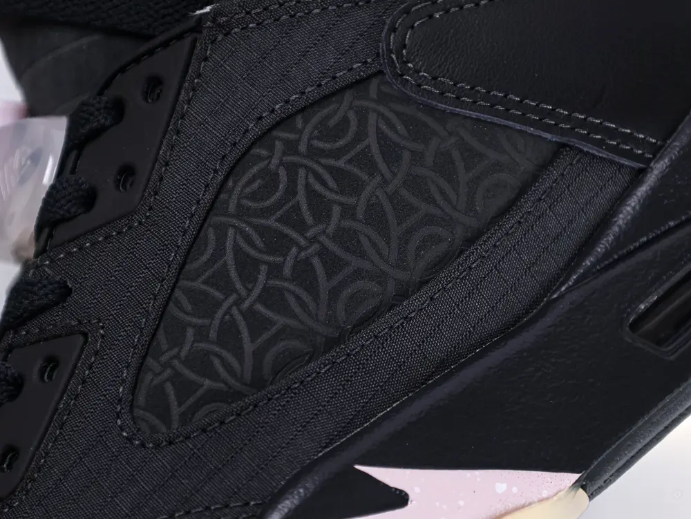 Lateral mesh panel of the Jordan 5 Retro PSG Paris Saint-Germain ‘Off Noir’, featuring a breathable patterned design.