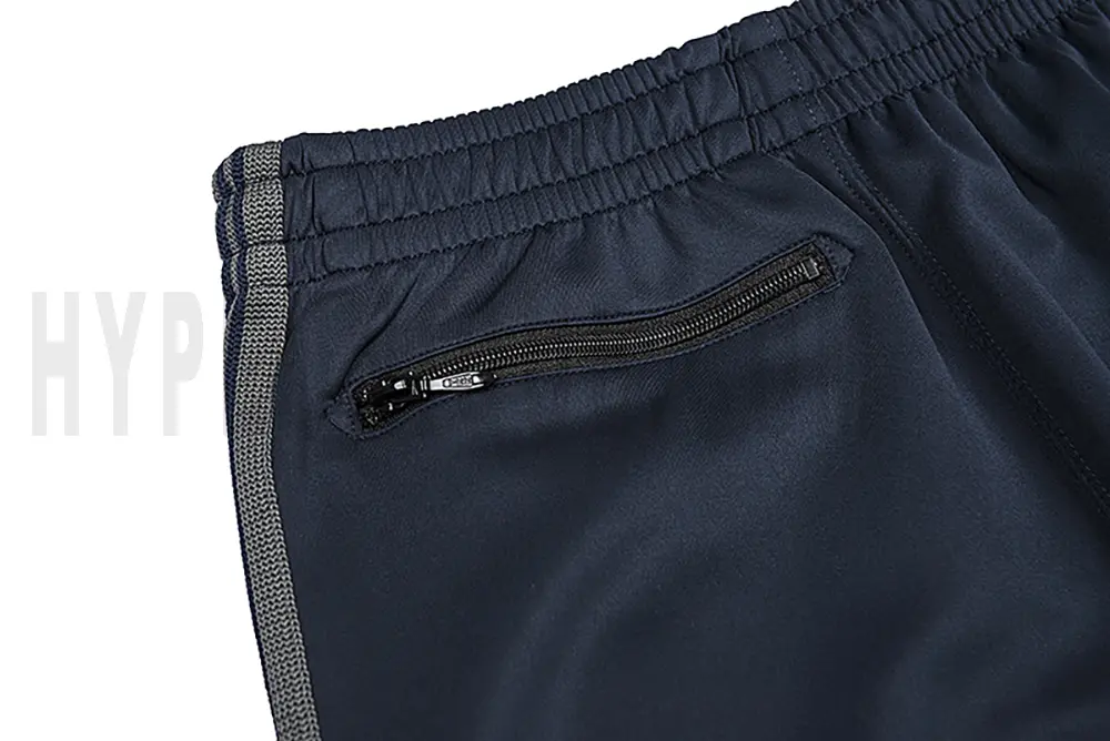 Detail of the back zip pocket on the track pants.