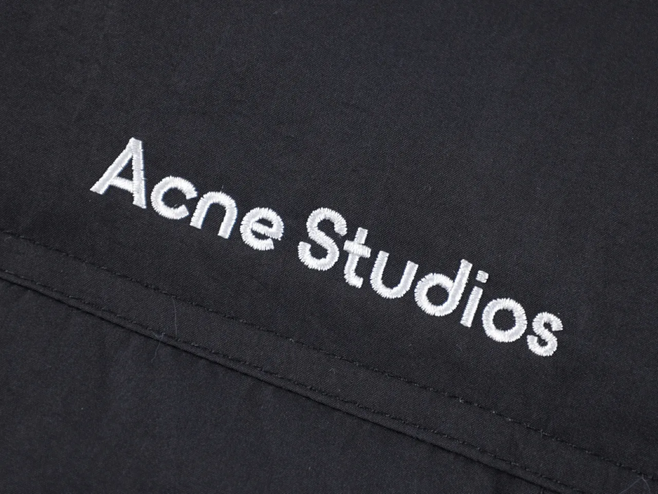Embroidered text, showcasing Acne Studios