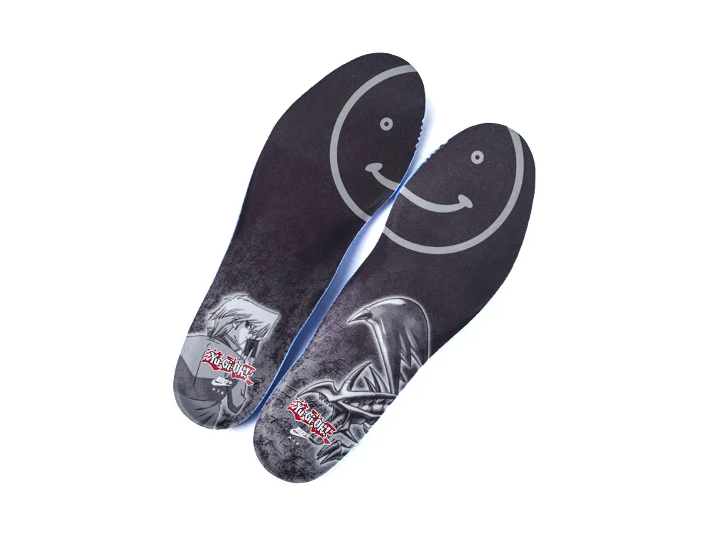 Dark insoles with printed graphics, featuring smiley face and character designs.