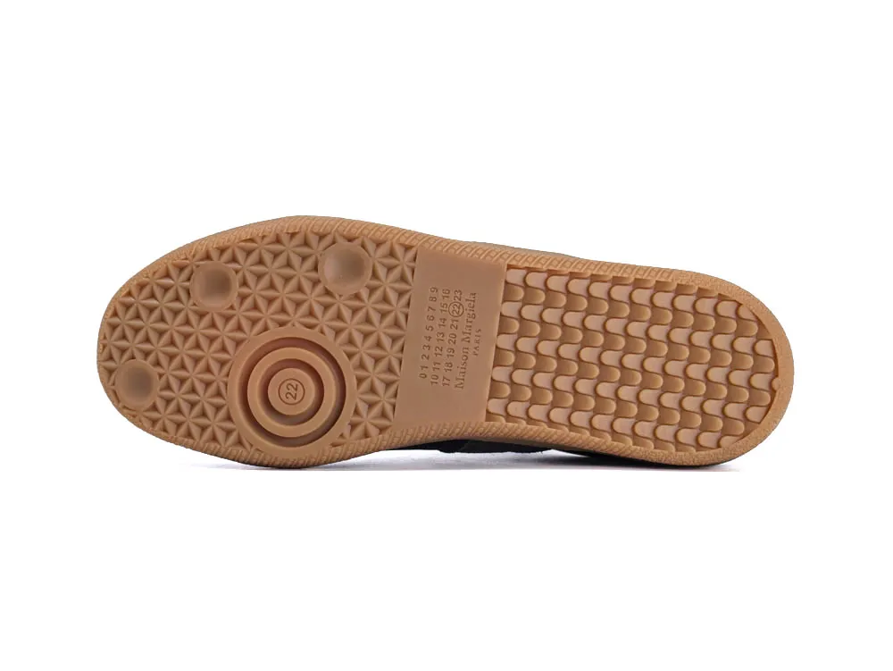 Beige rubber shoe sole with geometric patterns and textured grip surface.