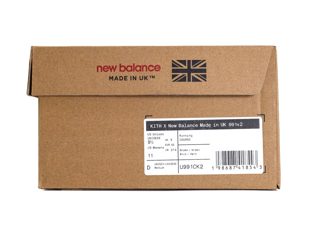 Brown cardboard shoe box with New Balance branding, featuring a printed label.