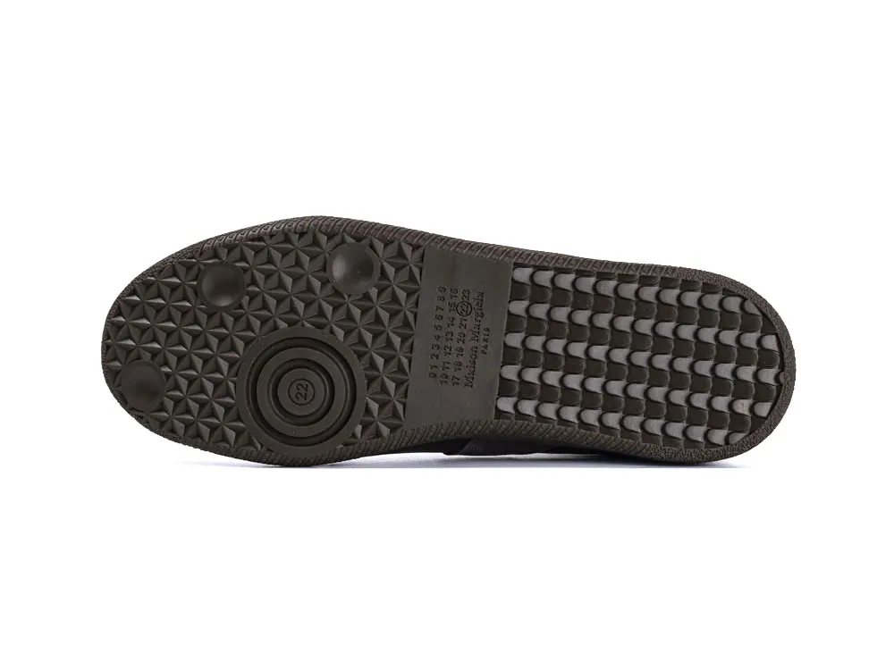 Black rubber shoe sole with textured grip pattern and embossed markings.