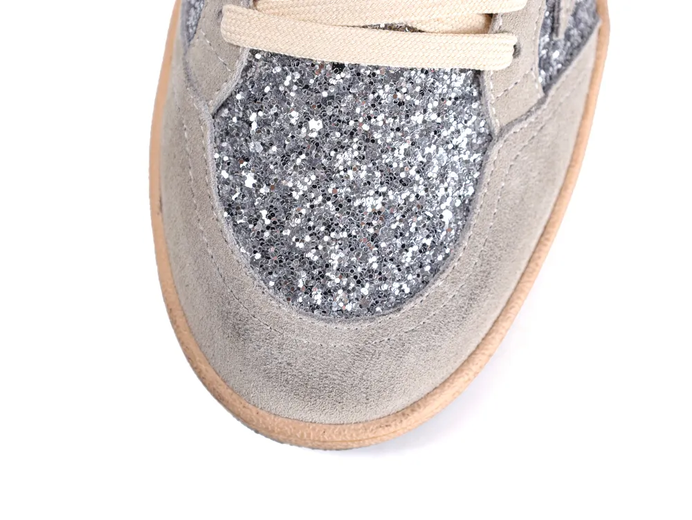 Top view of silver glitter toe box and grey suede trim on Golden Goose sneaker