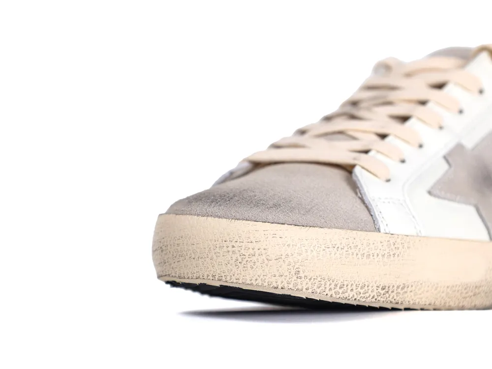 Close-up of distressed front toe on white leather sneaker