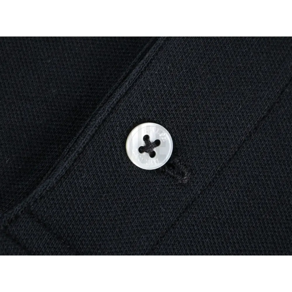 Close-up of button detail on the garment