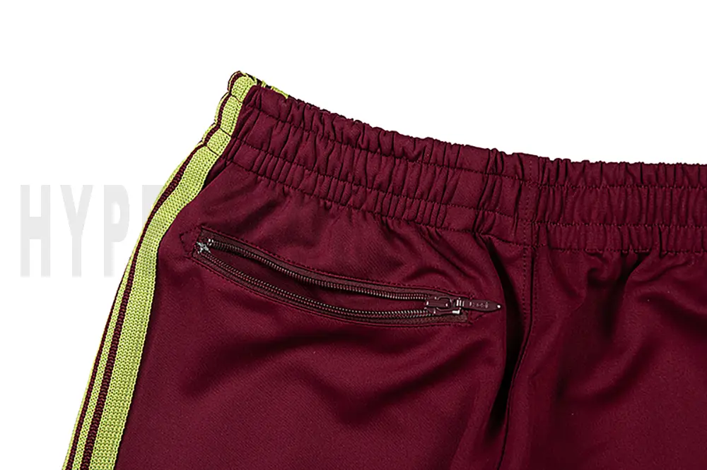 Detail of the back zip pocket on the track pants.