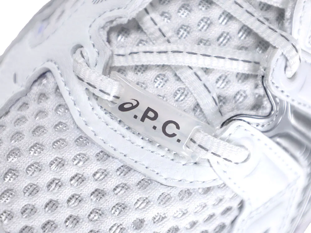 Close-up of silver mesh sneaker upper with white laces and "A.P.C." logo tag.
