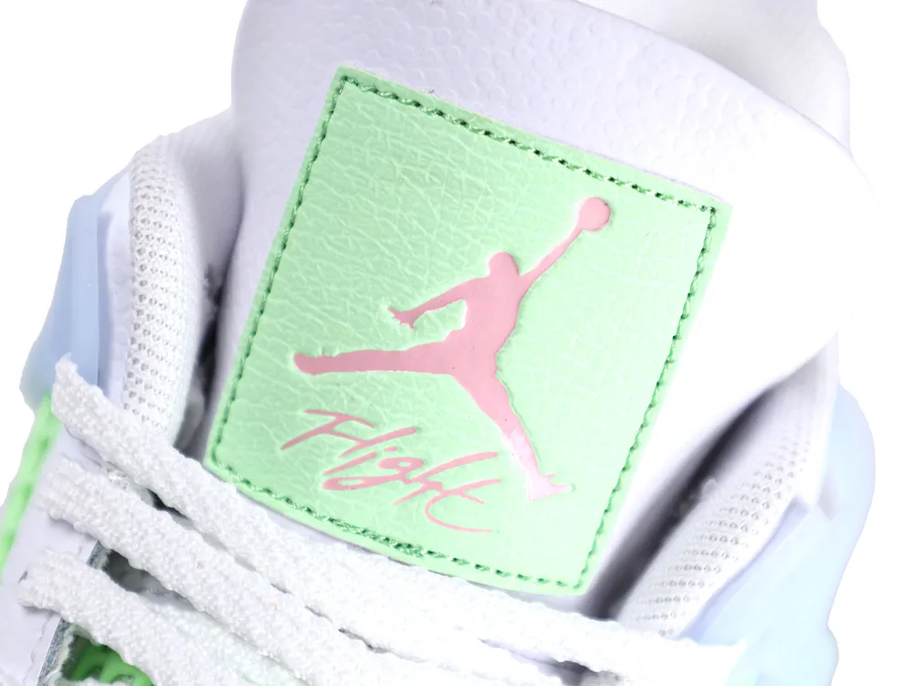 Close-up of Jordan 4 tongue with a mint green patch and pink Jumpman Flight logo.