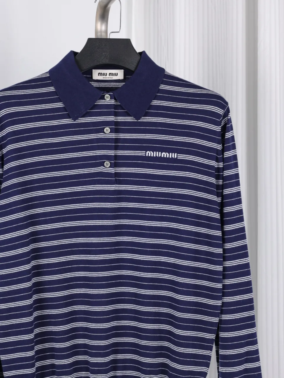 Blue and white striped cotton shirt with a collar and button-up front.