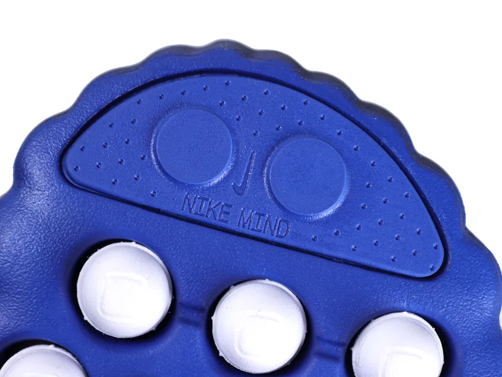 Detailed view of the royal blue outsole toe area with "NIKE MIND" embossed text.
