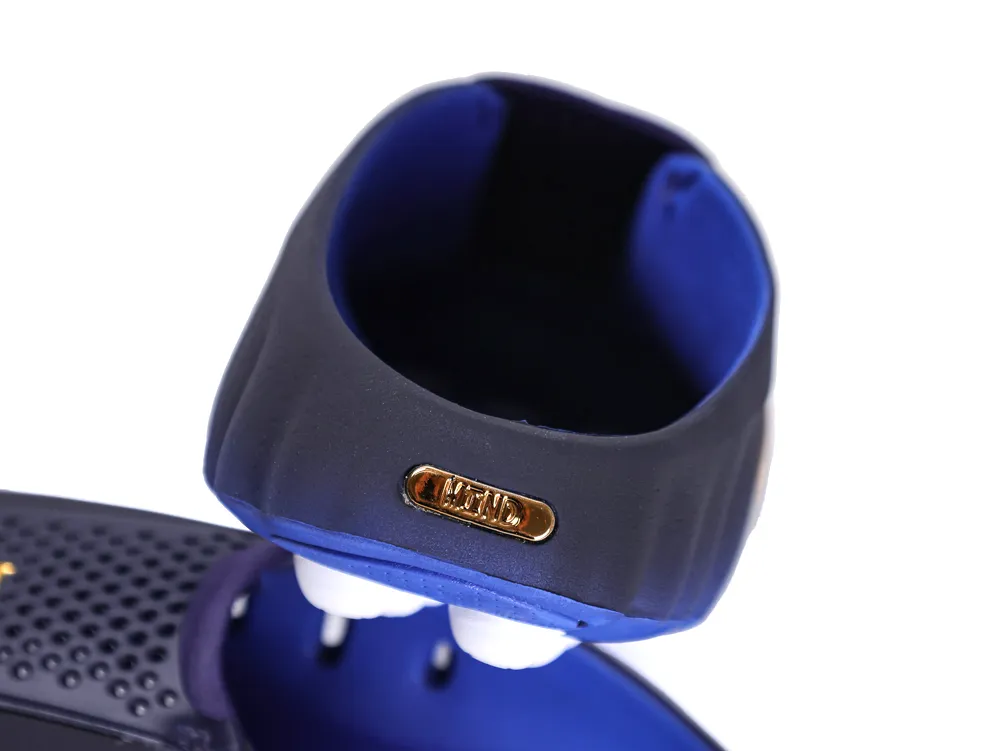 Close-up of the heel counter featuring a small metallic gold "MIND" badge on a navy blue upper.