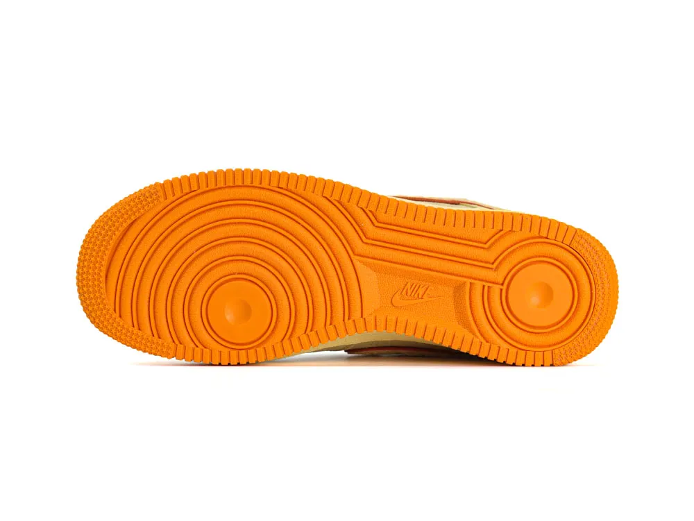 Orange rubber sneaker sole with textured grooves and circular patterns.