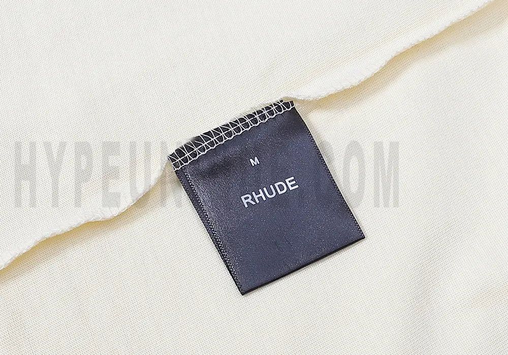 Close-up of the T-shirt's neckline tag, showcasing wash care instructions and brand details in a fashion design.