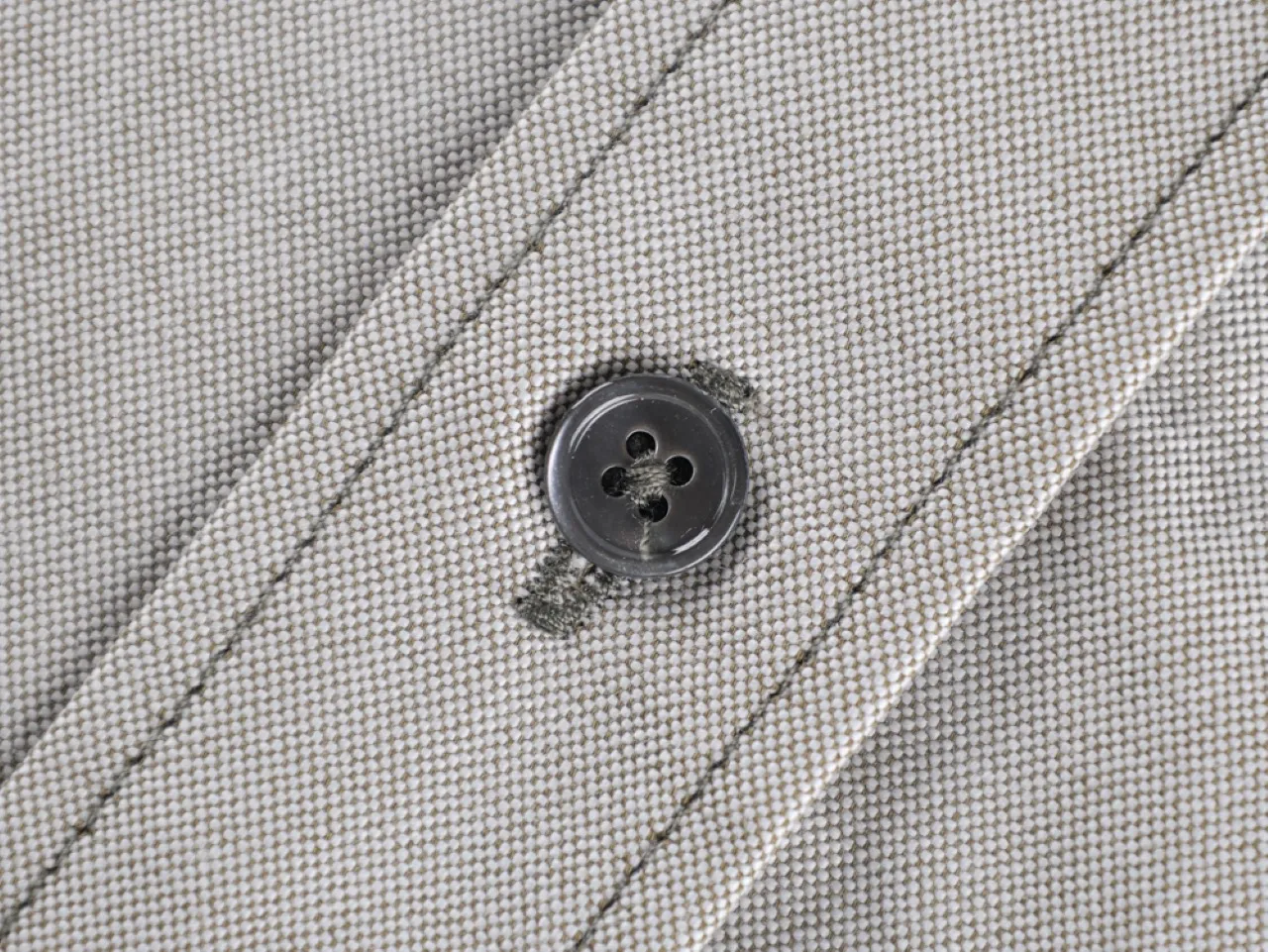 Close-up of black button detail.