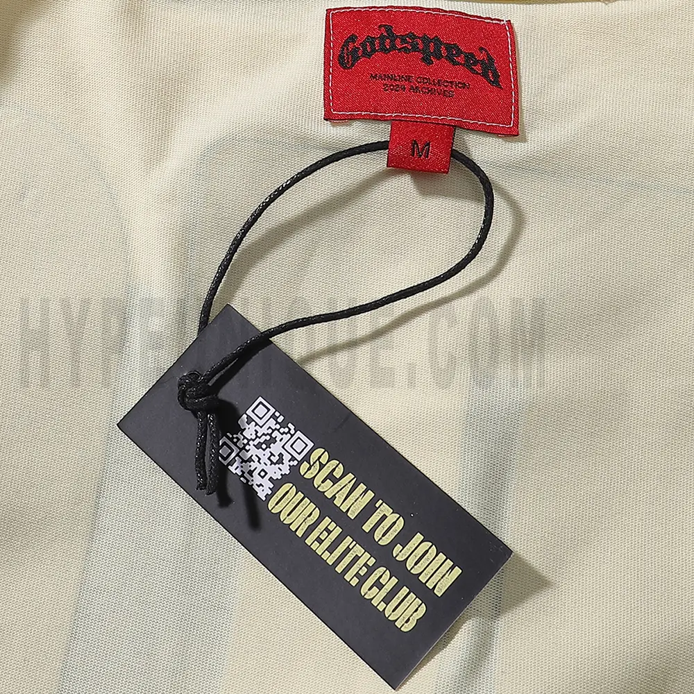 Close-up of the tee's featuring wash care instructions and subtle brand branding in a clean, minimalist typography