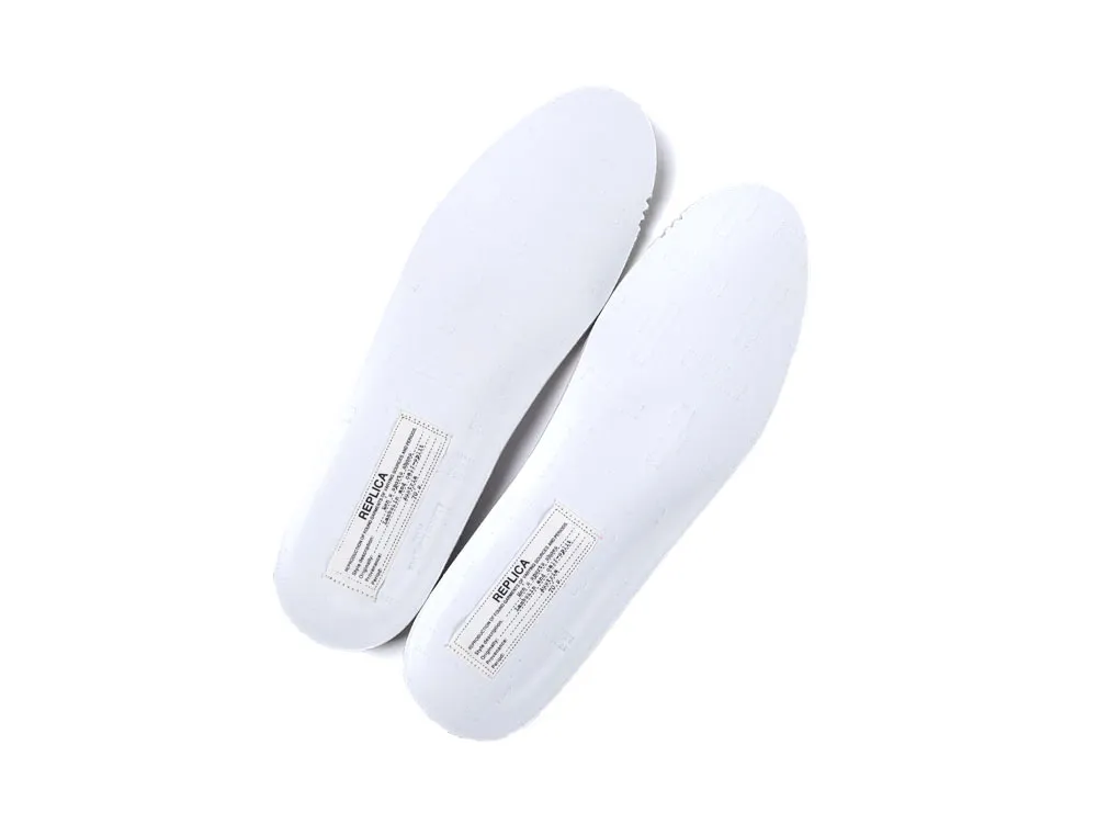 White rubber insoles with printed label, designed for comfortable shoe fitting.