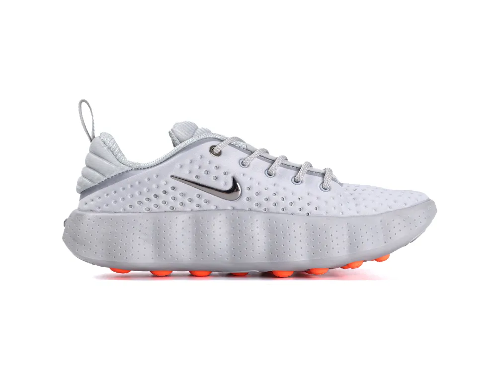 White and grey sneaker with perforated upper, rubber sole, and orange grip accents.