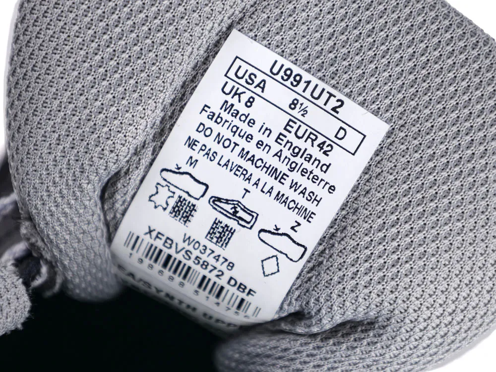 Close-up of a gray mesh fabric shoe with care label insole.