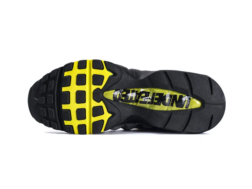 Black and yellow rubber sneaker sole with textured grip pattern.