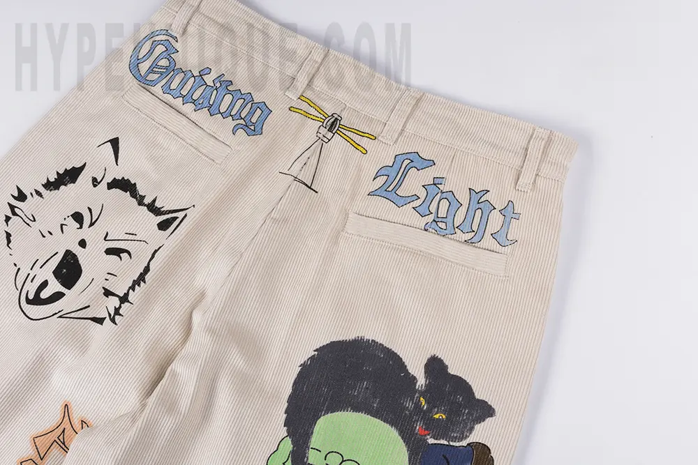 Back pocket detail view of the KAPITAL Ivy Wide-Leg Pleated Printed Cotton-Corduroy Trousers.