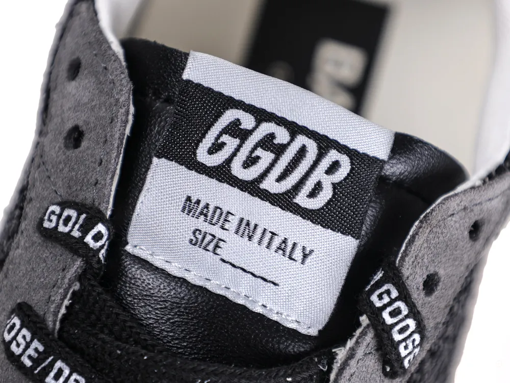 Close-up of GGDB Made in Italy logo patch on sneaker tongue