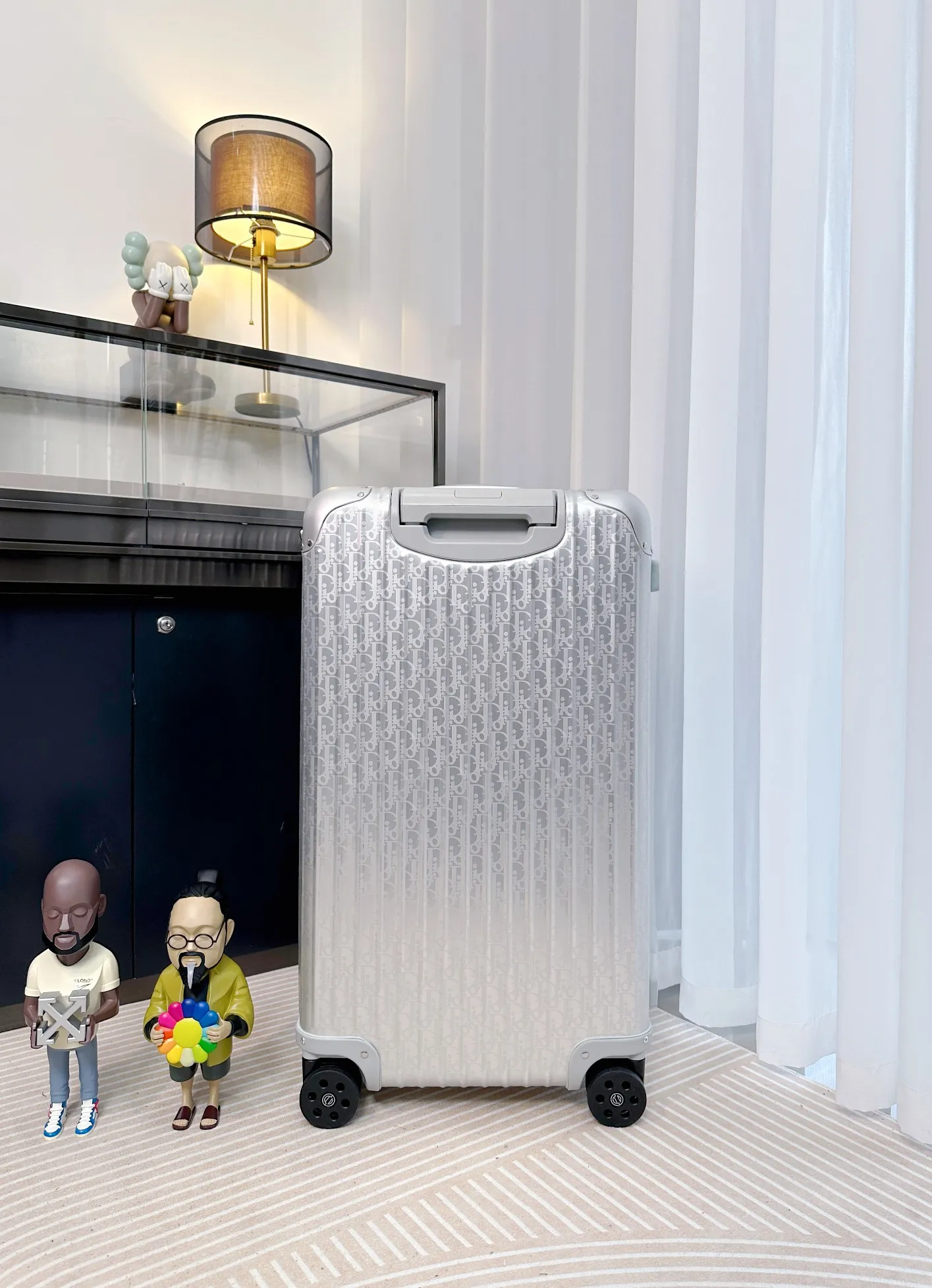 Silver rolling suitcase rear view