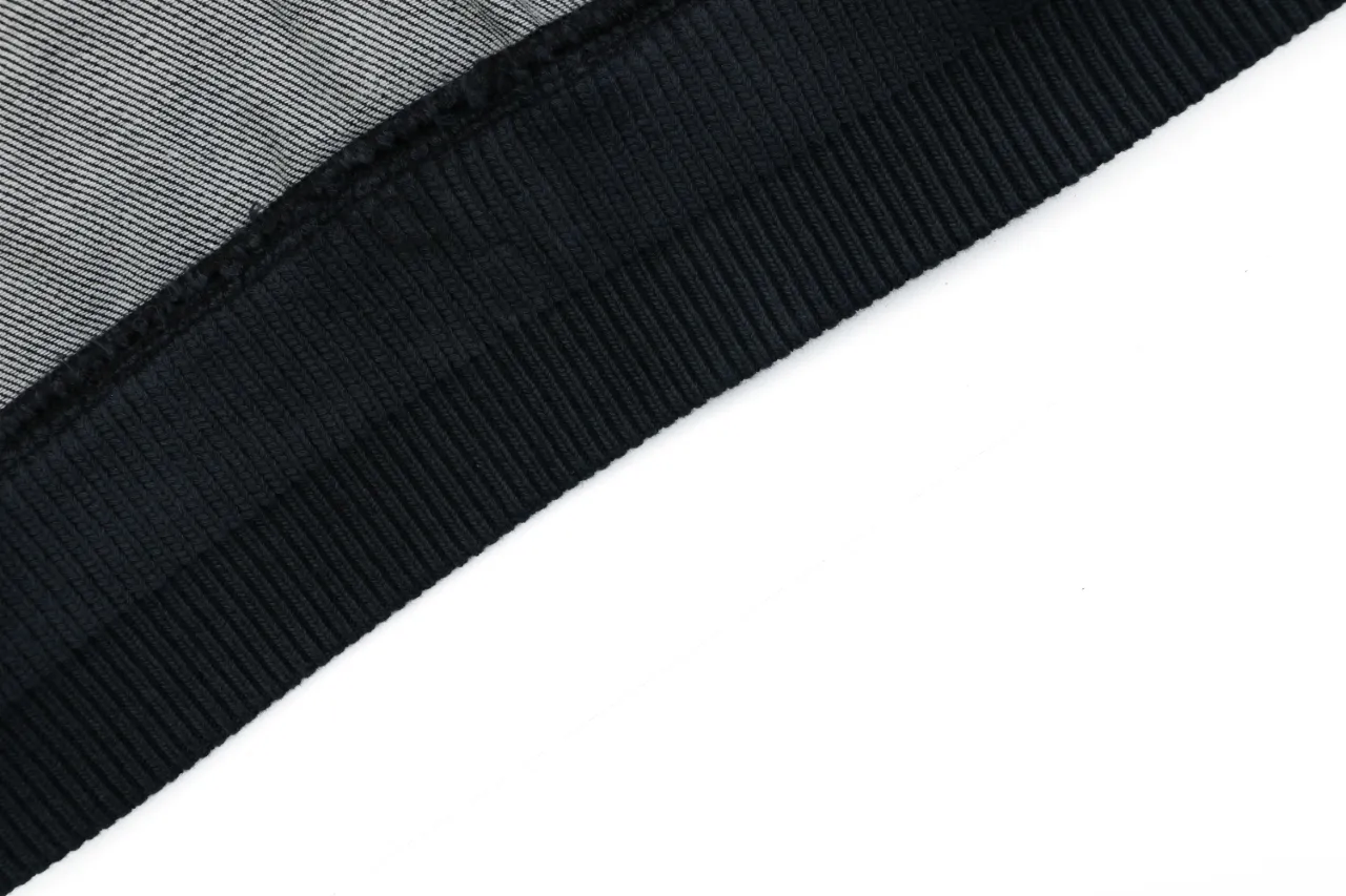 Black ribbed fabric detail with striped gray material