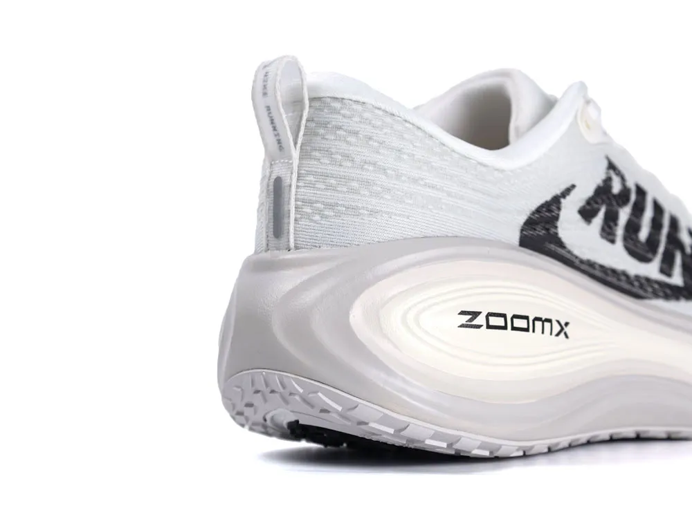 Gray and white sneaker with ZoomX sole, mesh fabric, and "RUN" text detail.