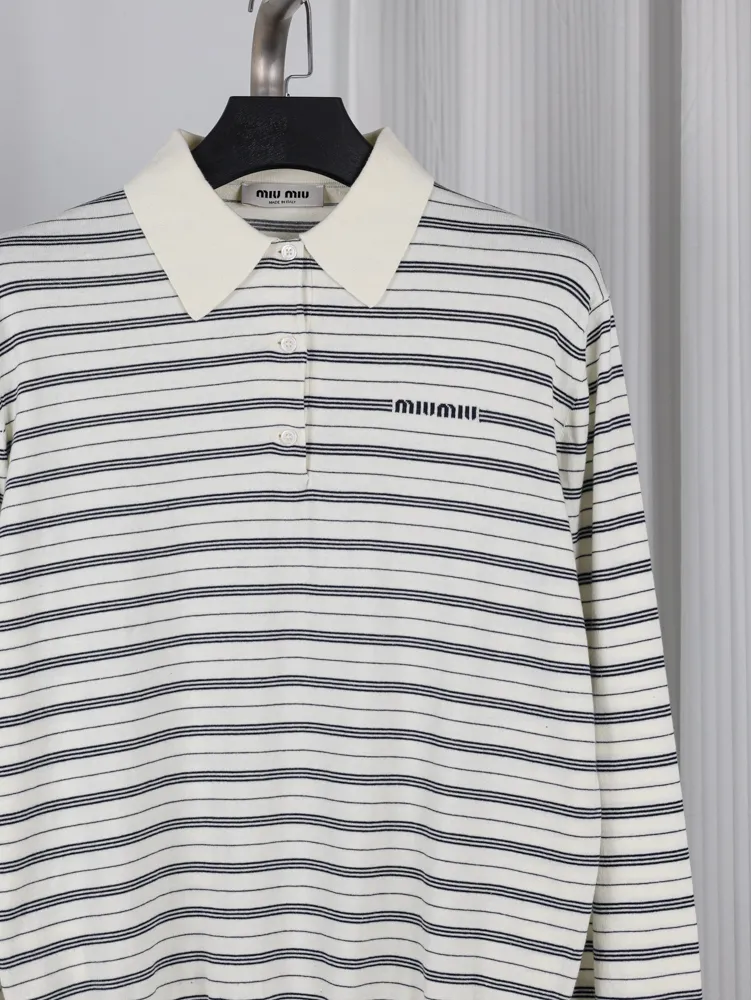 Striped black and white cotton shirt with a cream collar and button details.