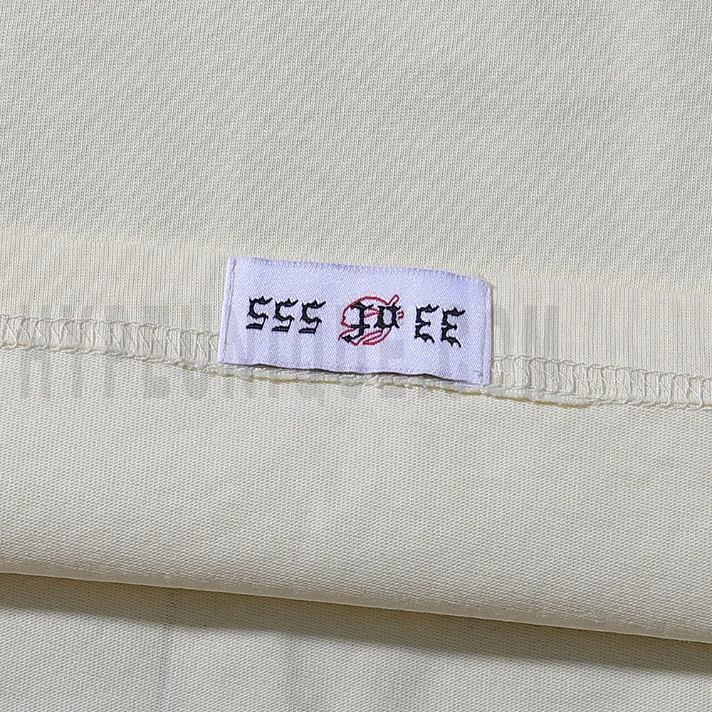 Clean hemline finish with a modern cut, highlighting the T-shirt's streetwear aesthetic.