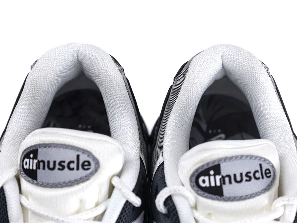 Gray and white fabric sneakers with padded collars and branded tongue labels.