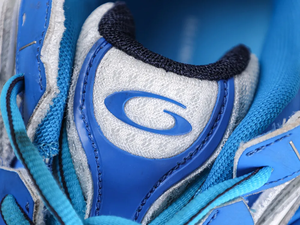 Blue and white sneaker tongue with textured fabric and logo detailing.