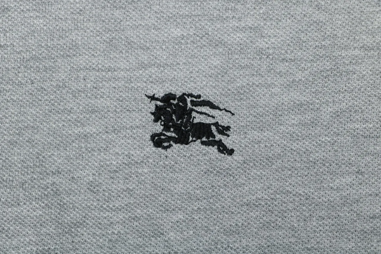 Black embroidered knight design, close-up detail.