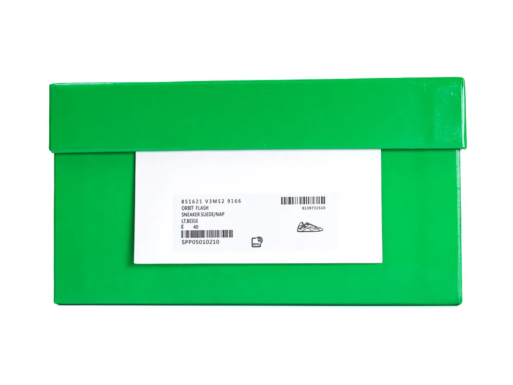 Green cardboard shoe box with a white label on the top side.