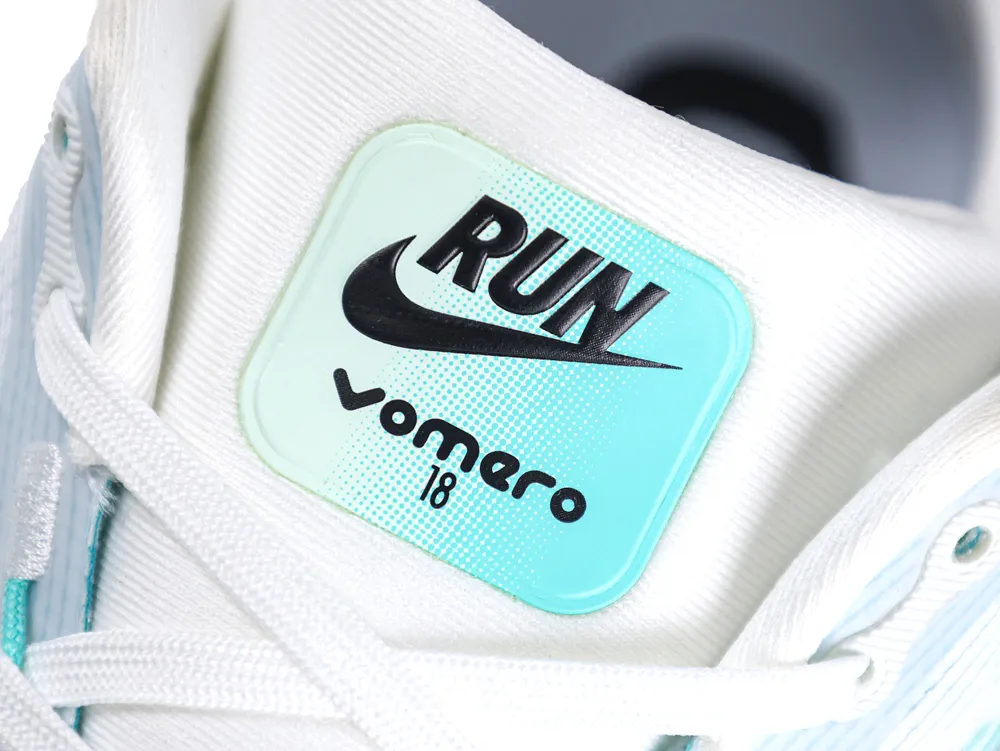 White and mint green sneaker with textured laces and a synthetic material label.