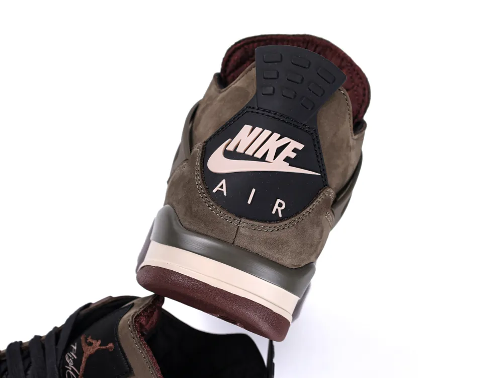 Brown suede sneaker with prominent black heel tab featuring a logo.
