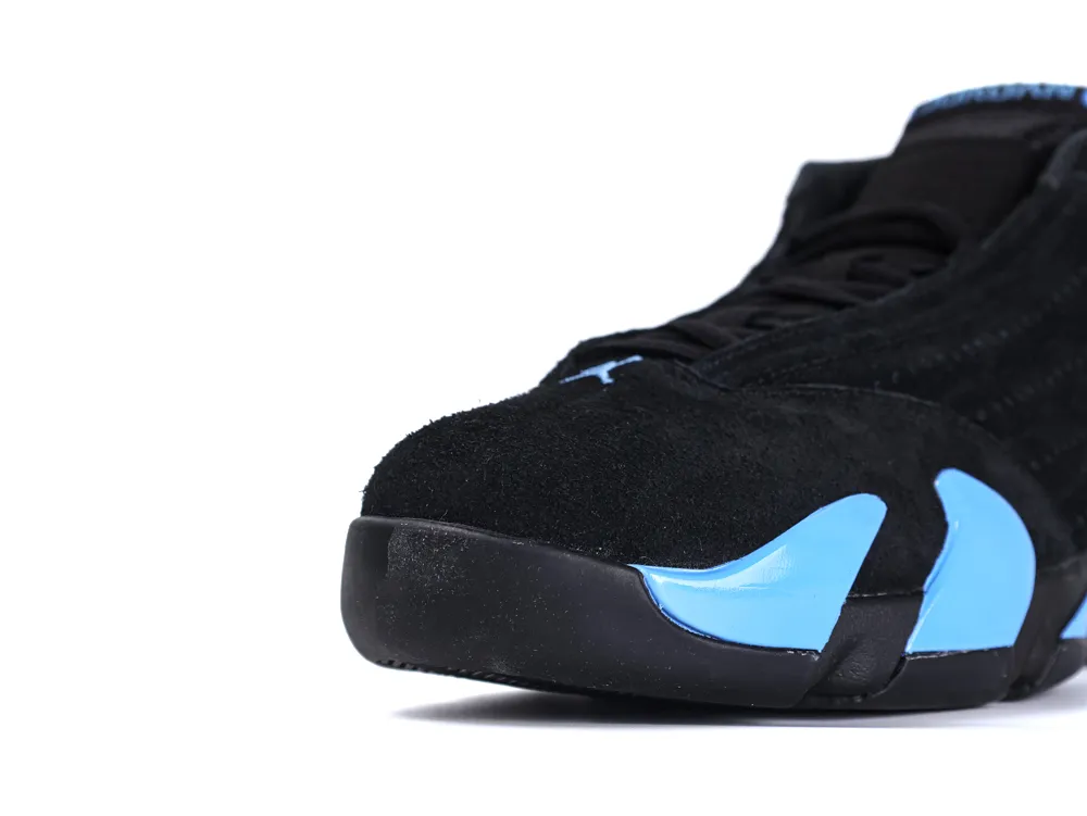 Black suede shoe with blue accents, focusing on the toe and side details.