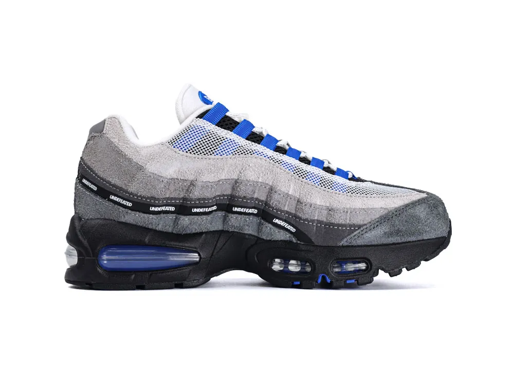 Gray suede and mesh sneaker with blue accents and black sole.
