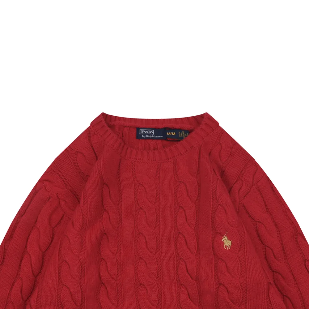 Red cable-knit sweater with a ribbed collar, featuring an embroidered logo.