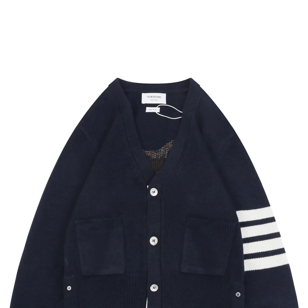 Navy wool cardigan with white striped sleeve and front pockets, button closure.