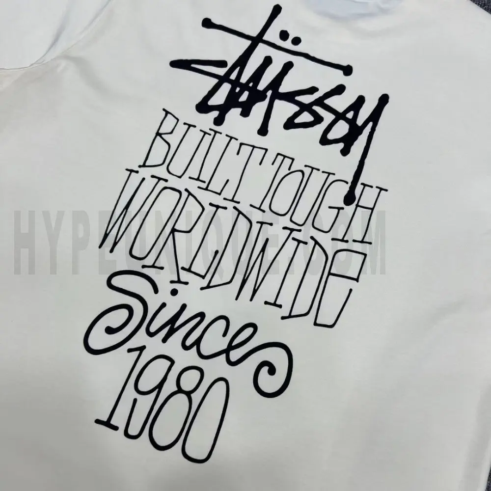 Detailed shot capturing the graphic print on the white tee's back panel.