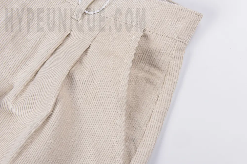 Side pocket detail view of the KAPITAL Ivy Wide-Leg Pleated Printed Cotton-Corduroy Trousers.